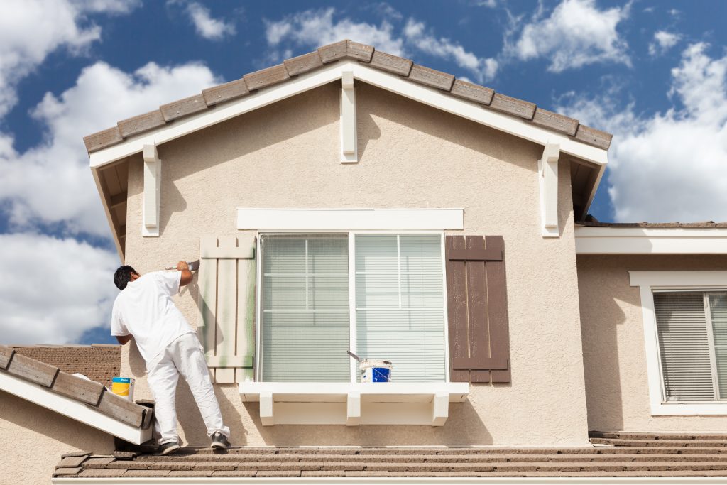 Painter preparing a Cape Town house exterior during the best dry season for painting